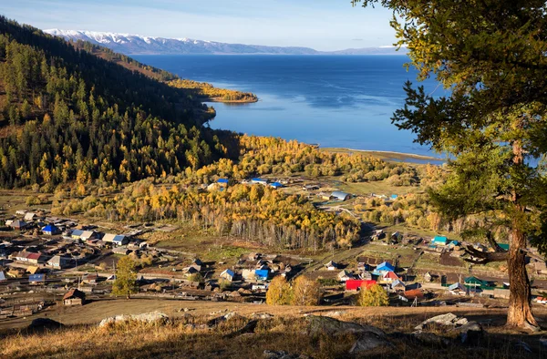 Village on coast of lake in mountains — Stock Photo, Image