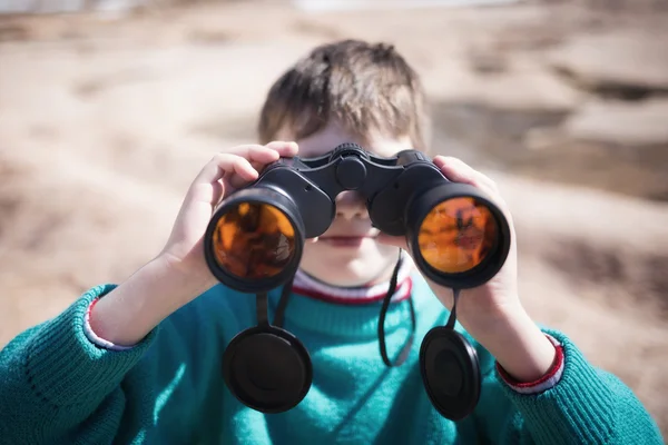 Boy looking with binoculars