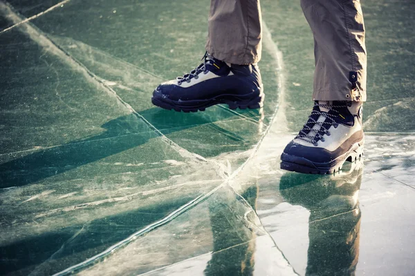 Legs in boots on the ice — Stock Photo, Image