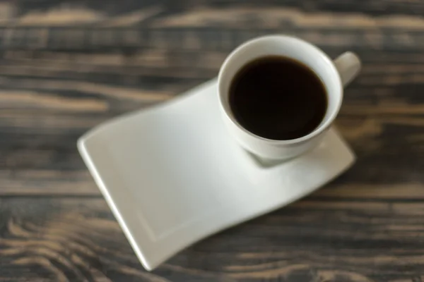 Artistic coffee cup with black coffee on wooden table, shallow focus — Stock Photo, Image