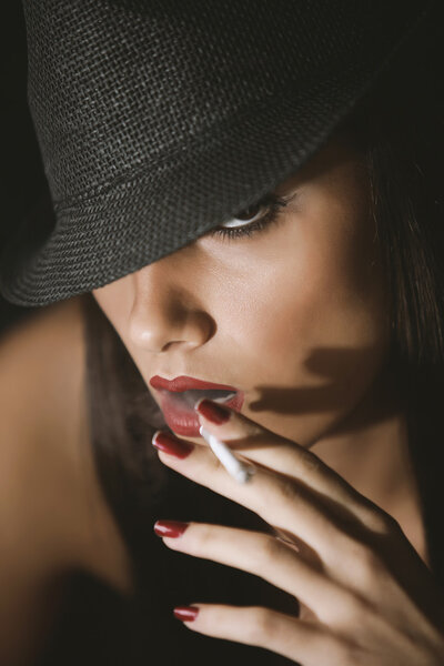 Fashion glamour woman with a cigarette and a hat