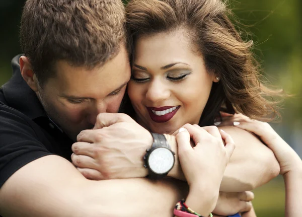 Happy couple in love, young man hugging young woman