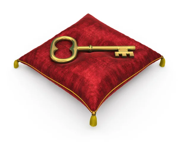 Golden key on royal red velvet pillow isolated on white backgrou — Stock Photo, Image