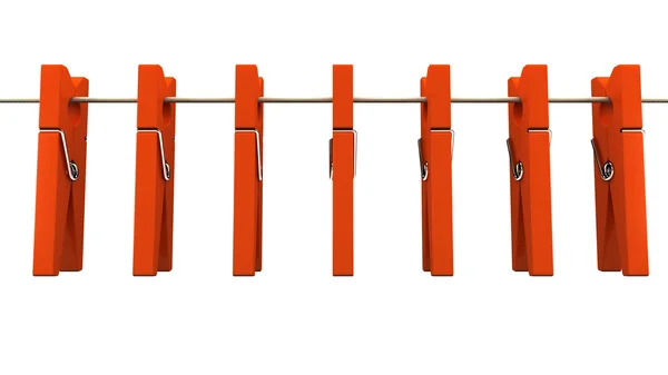 Червоні дерев'яні прищіпки на мотузці — стокове фото