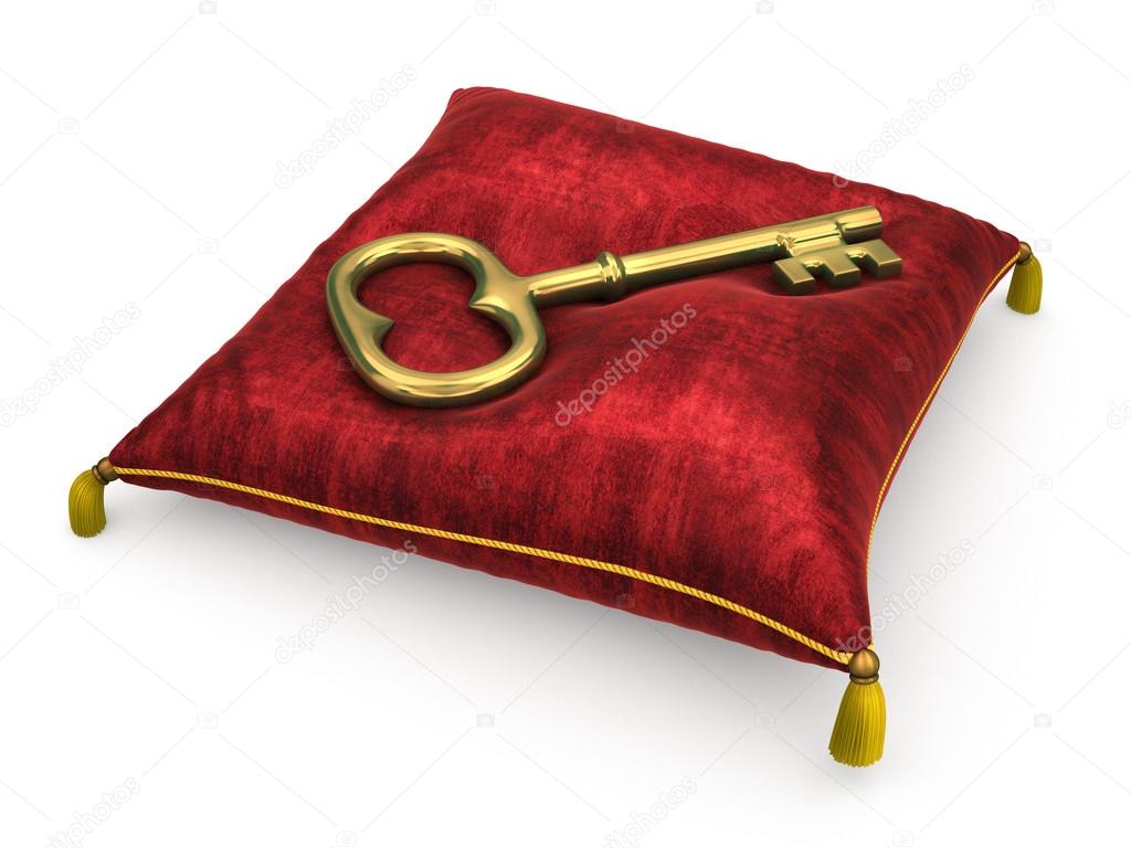 Golden key on royal red velvet pillow isolated on white backgrou