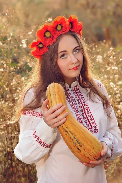 Girl in the Ukrainian national native costume with zucchini — Stock Photo, Image