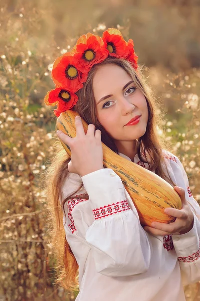 Girl in the Ukrainian national native costume with zucchini — Stock Photo, Image