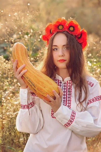 Girl in the Ukrainian national native costume with zucchini — Stock Photo, Image