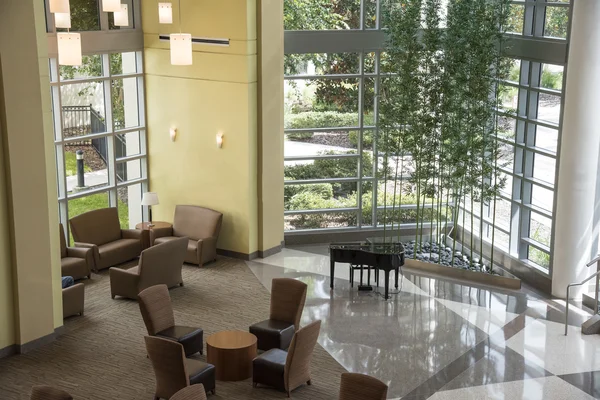 Lobby Atrium area with a piano and chairs — Stock Photo, Image