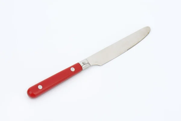 Нож для стола с красной ручкой — стоковое фото