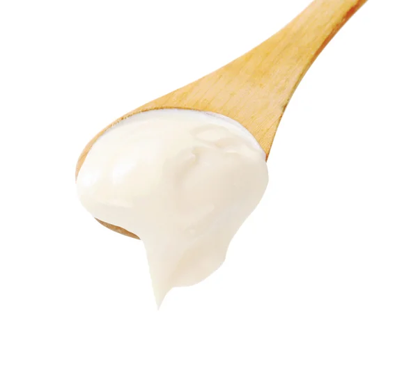 Sour cream on a wooden spoon — Stock Photo, Image