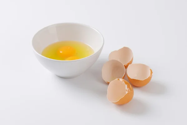 Cracked eggs in a bowl — Stock Photo, Image