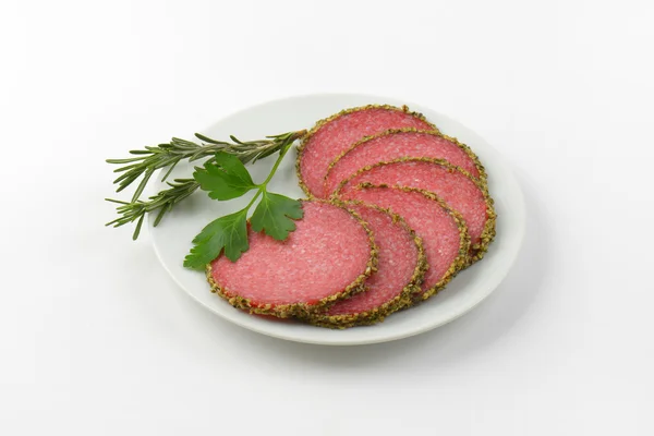 Slices of pepper coated salami — Stock Photo, Image