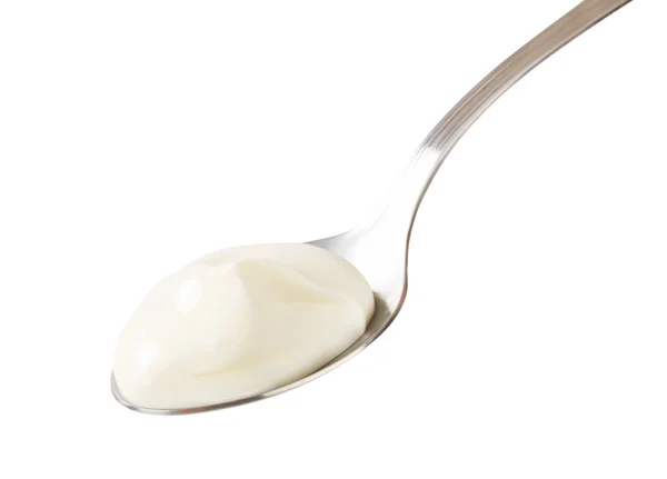 White yogurt on a spoon — Stock Photo, Image