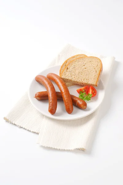 Cooked sausages with bread — Stock Photo, Image