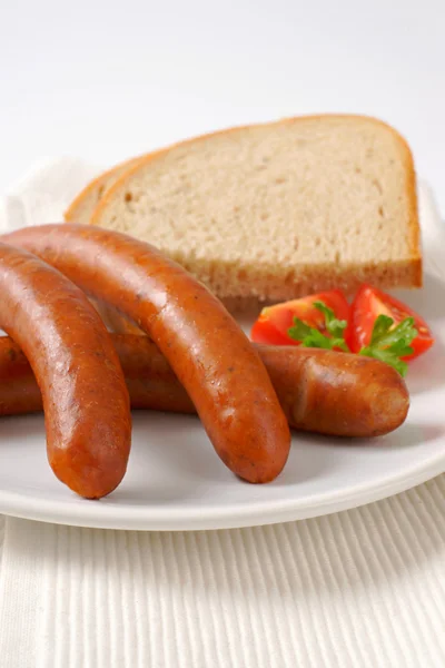 Cooked sausages with bread — Stock Photo, Image