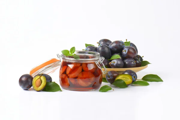 Fresh and bottled plums — Stock Photo, Image