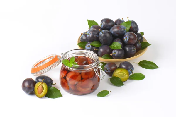 Fresh and bottled plums — Stock Image Fresh and bottled plums Royalty Free Stock Photos