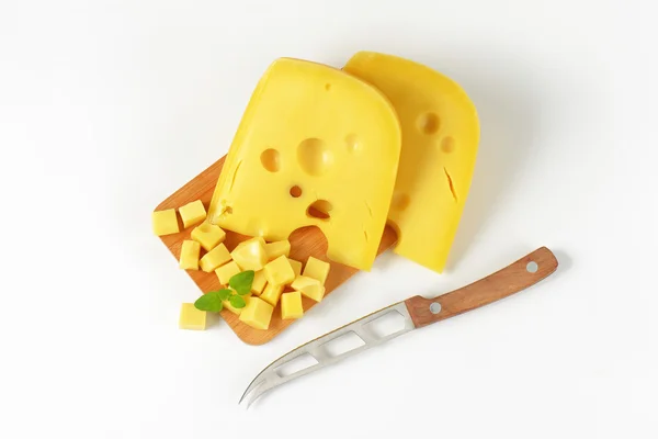 Wedges and cubes of Swiss cheese — Stock Photo, Image