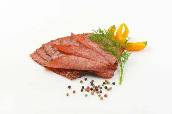 Thin sliced pepper coated salami — Stock Photo, Image