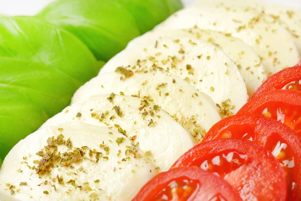 Mozzarella, tomatoes and fresh basil — Stock Photo, Image