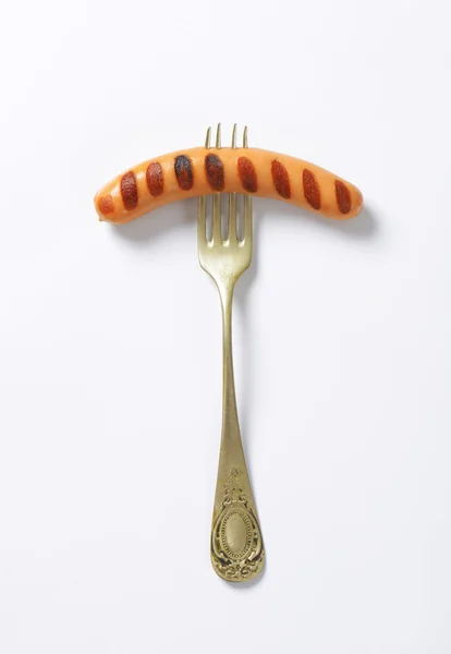 Grilled sausage on fork — Stock Photo, Image