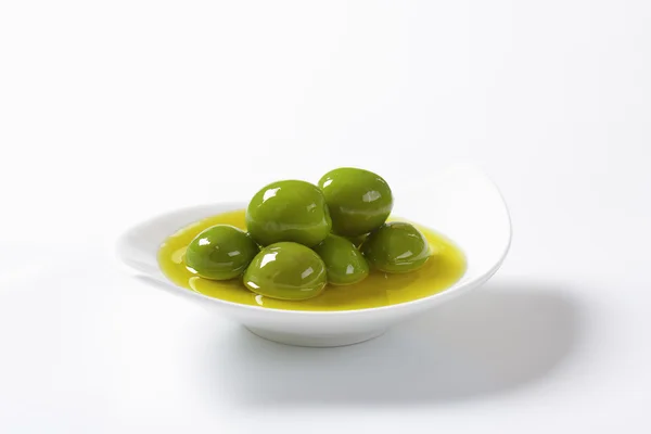 Green olives in oil — Stock Photo, Image