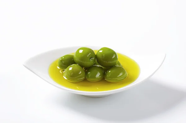 Green olives in oil — Stock Photo, Image