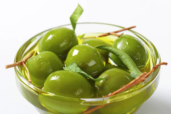 Green olives in oil — Stock Photo, Image