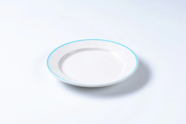 Empty rimmed dinner plate — Stock Photo, Image