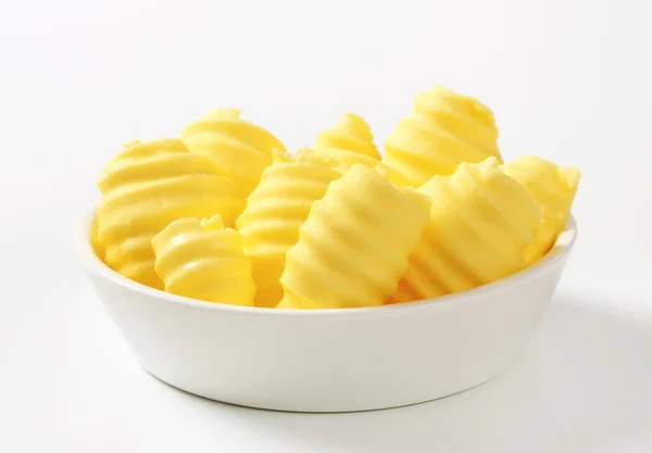 Bowl of butter curls — Stock Photo, Image