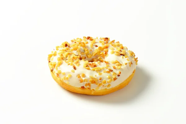 Glazed donut with nuts — Stock Photo, Image