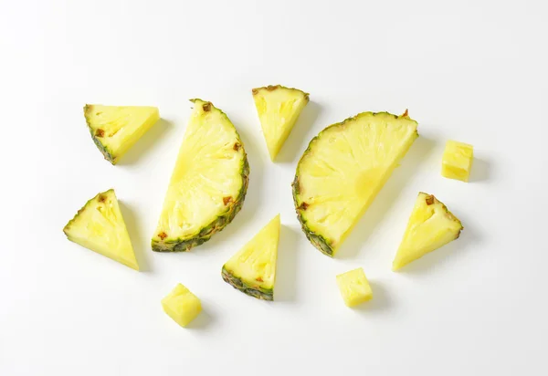 Fresh pineapple slices and wedges — Stock Photo, Image