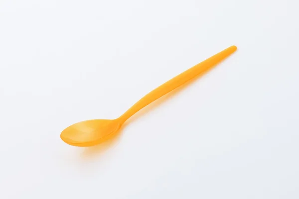 Orange plastic spoon — Stock Photo, Image