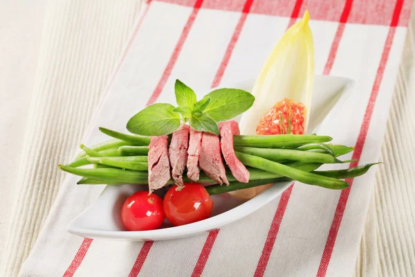 Strips of roast beef  and string beans — Stock Photo, Image