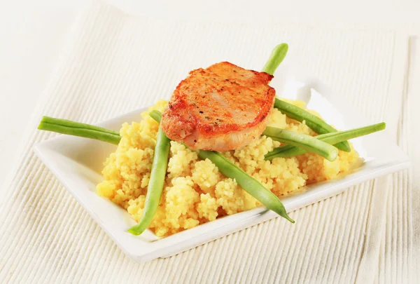Marinated pork with couscous and green beans — Stock Photo, Image