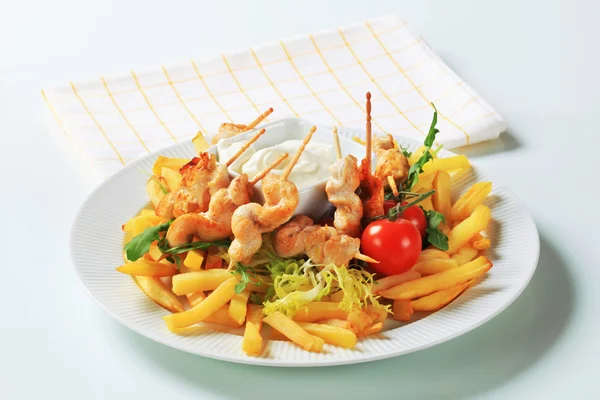 Chicken satay with French fries — Stock Photo, Image