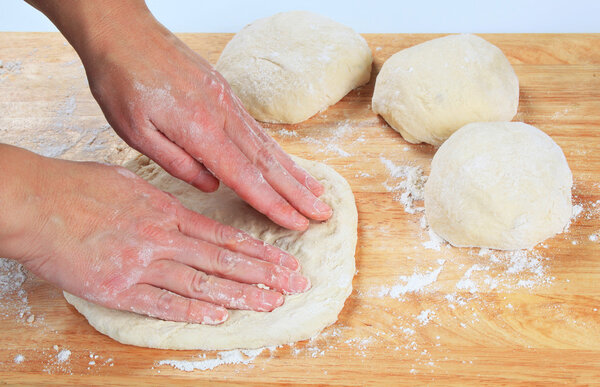 Cook preparing pizza