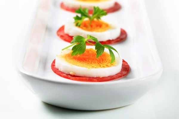 Slices of salami and boiled egg — Stock Photo, Image