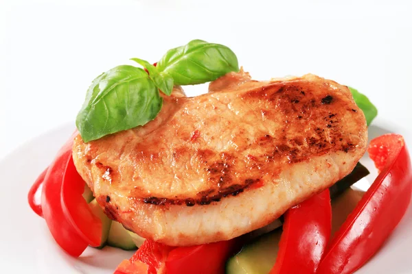 Pork cutlet with red pepper and zucchini sticks — Stock Photo, Image