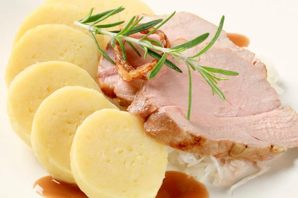 Varkensvlees met aardappel knoedels en witte kool — Stockfoto