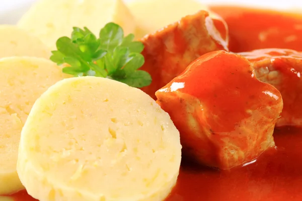 Pork meat in tomato sauce with potato dumplings — Stockfoto