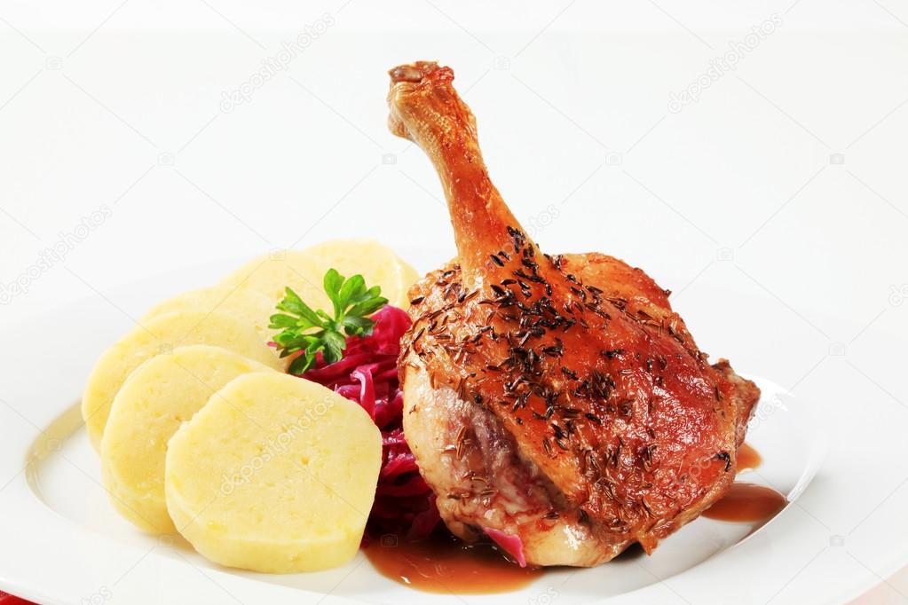 Roast duck leg with potato dumplings and red cabbage