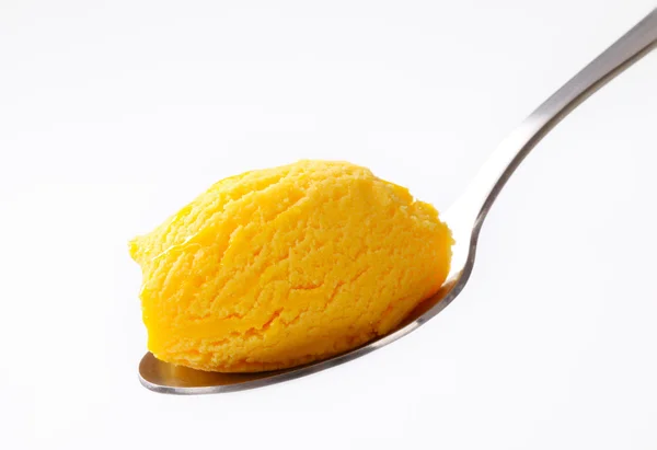 Yellow ice cream on spoon — Stock Photo, Image