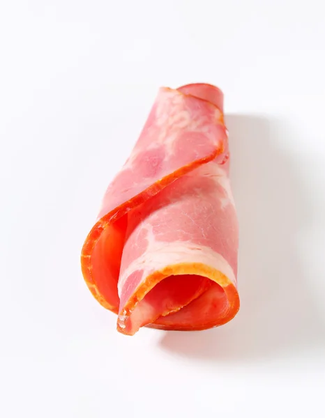 Slice of smoked pork - rolled up — Stock Photo, Image