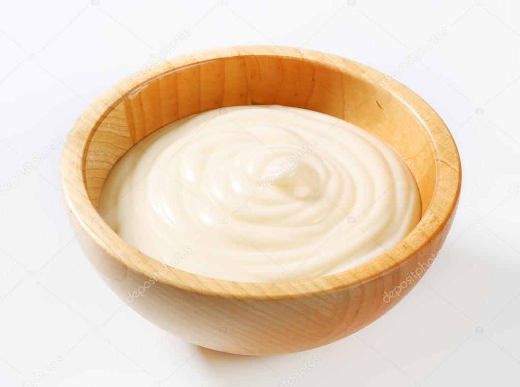 Creamy sauce in wooden bowl