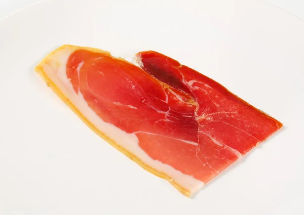 Slice of prosciutto crudo — Stock Photo, Image