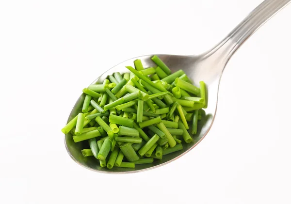 Chopped chives on spoon — Stock Photo, Image