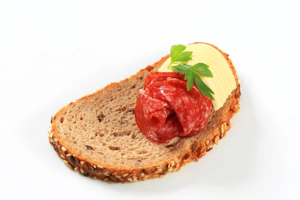 Bread with butter and salami — Stock Photo, Image