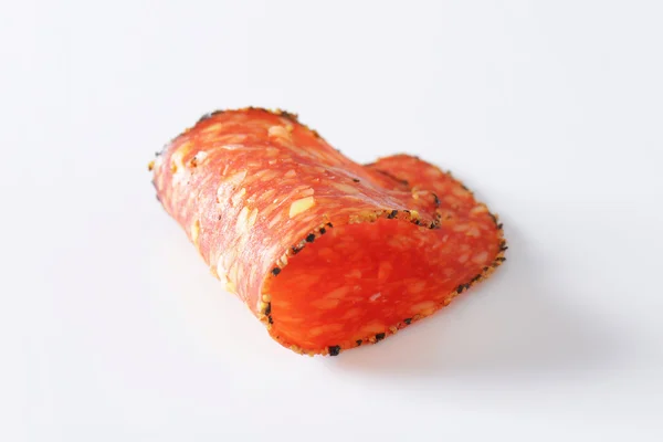 Black pepper-coated salami with cheese — Stock Photo, Image